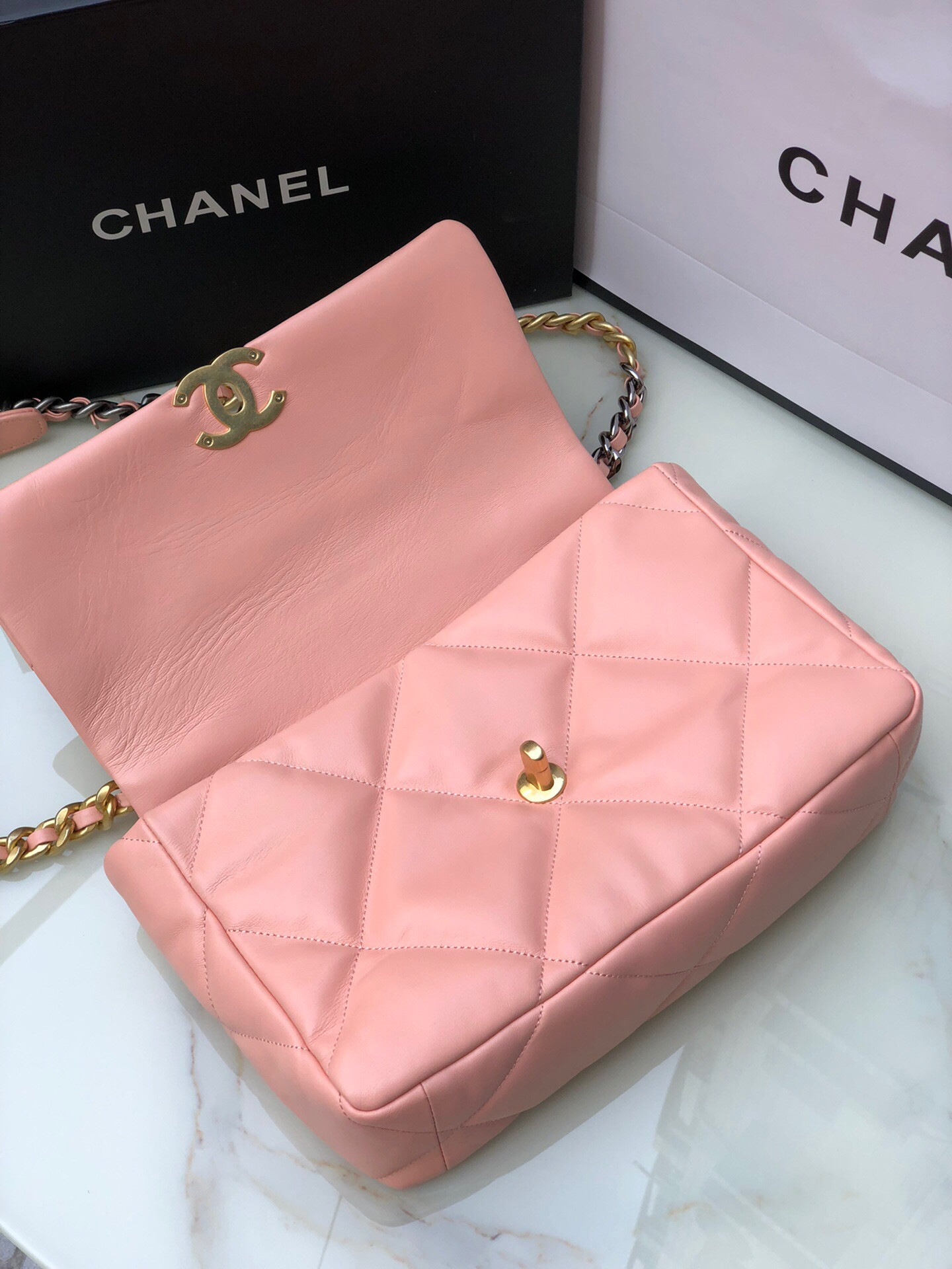 Ch*el 19 large handbag shiny leather, gold-tone, silver-tone & ruthenium-finish metal light pink 7.8 × 11.7 × 3.9 in